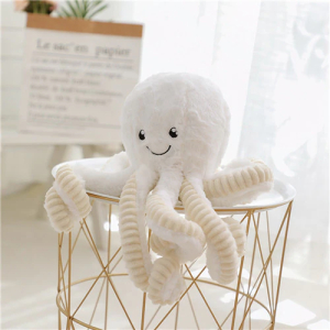 Cute white octopus plush on a small decorative table