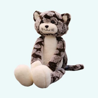 Long-legged grey plush cat sitting .