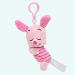 A Piglet plush who's already asleep when it's time to shut up, in the shape of a key ring on a plain background.