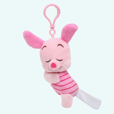 A Piglet plush who's already asleep when it's time to shut up, in the shape of a key ring on a plain background.