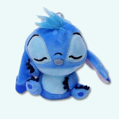 Stitch plush keychain on light blue background.