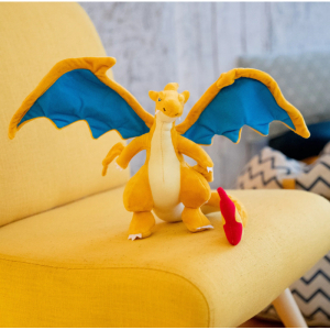 orange plush with open wings on a yellow chair