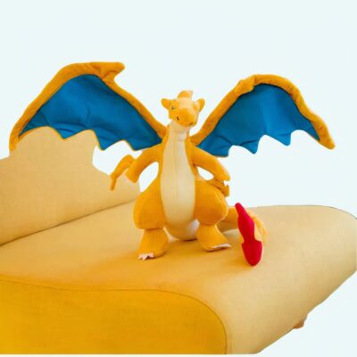 orange plush with open wings on a yellow chair