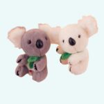 Cute grey and white koala plush on a light blue background.
