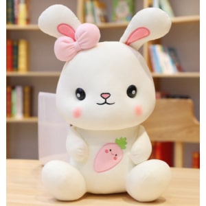 Cute white bunny sitting on a table in front of a piece of furniture