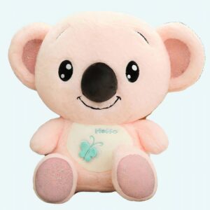 Soft pink koala plush sitting on a sofa