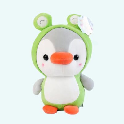 Penguin plush dressed as a frog on a light blue background.