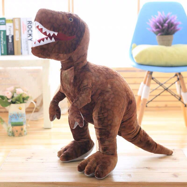 Fierce Brown Tyrannosaurus plush in front of a blue chair in a bedroom