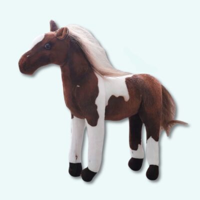 Cute brown and white plush horse on a light blue background.