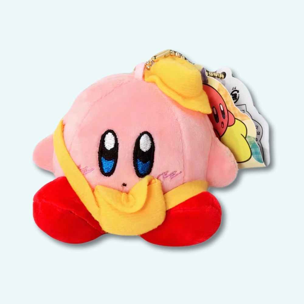 Kurby plush with yellow cap on a light blue background.