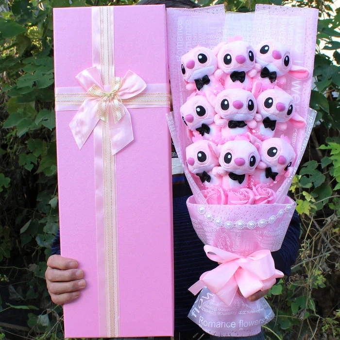 Flower bouquet with pink Angel plush in front of a tree