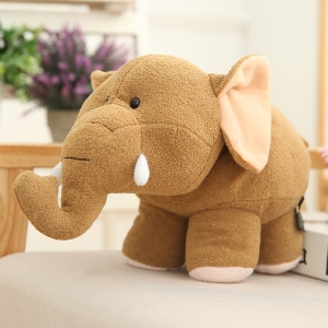 Brown elephant plush with big ears in front of a pante