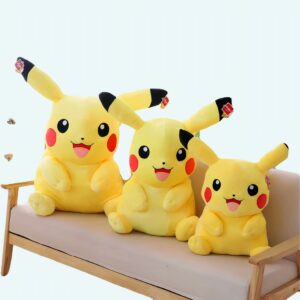 three pikachus of different sizes sitting on a beige sofa in a beautiful room