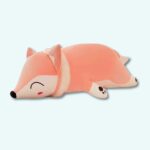 Plush fox pillow on a light blue background.