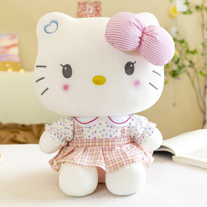 Cute Hello Kitty plush sitting in front of a book
