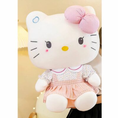 Cute Hello Kitty plush sitting in front of a book