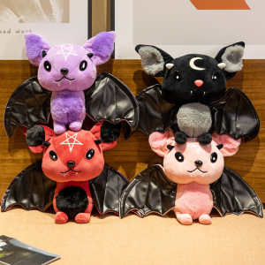 Halloween plush bat coloured on a bed