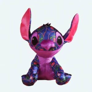 Stitch the disney cartoon hero plush who is coloured in dark purple with red rose patterns, and pink ears and belly, he is sitting with his ears in the air