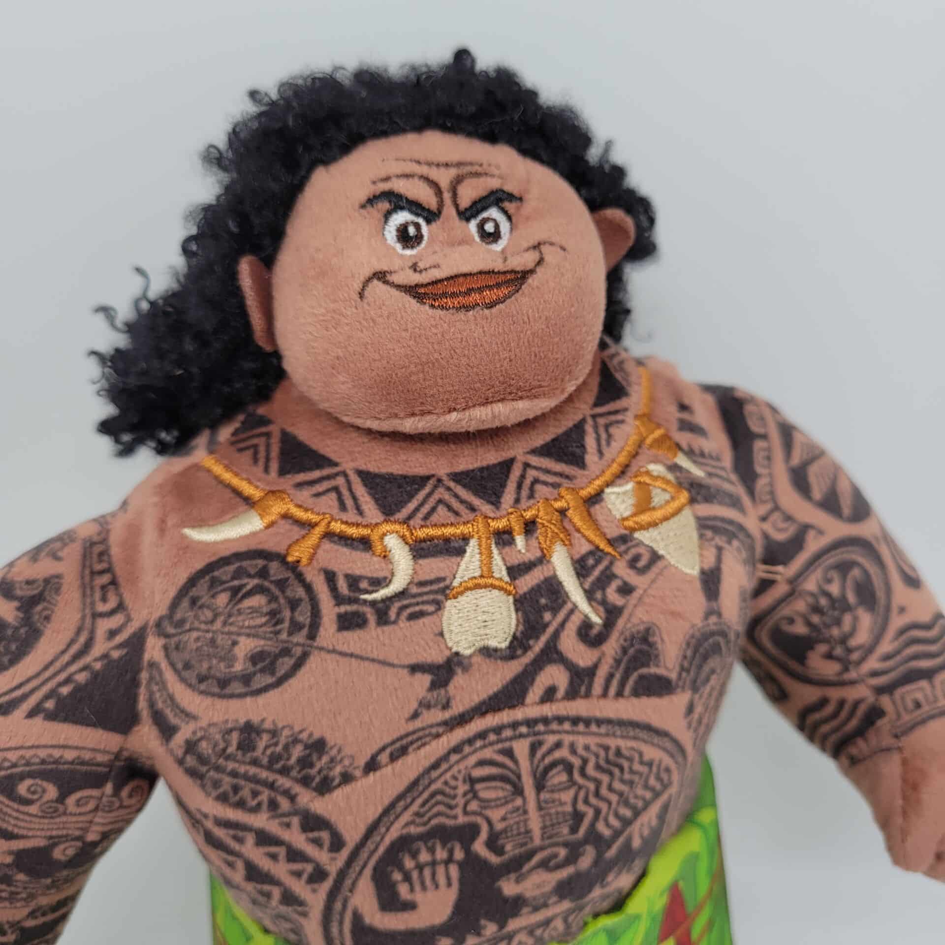 plush of the character Moana Maui from the disney cartoon we see her head and her bust entirely tattooed
