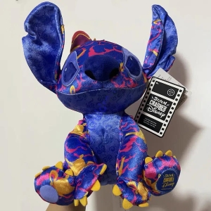 Stitch plush in dark purple with some fluorescent pink and orange colours, held by one hand