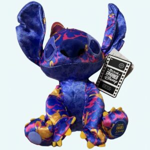 Stitch plush in dark purple with some fluorescent pink and orange colours, held by one hand