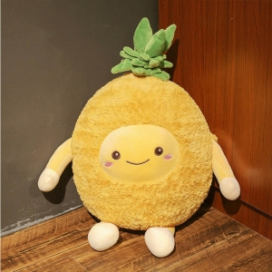 Yellow pineapple fruit plush smiling and sitting on a wooden floor and against a grey wall