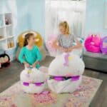 Sleepy-Chou the 2-1 white and pink plush with girls in a room