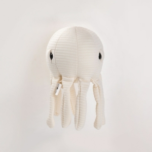 an ecru plush octopus with quilted fabric on a white background