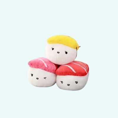 Three soft and cute sushi plush cushions on a solid light blue background