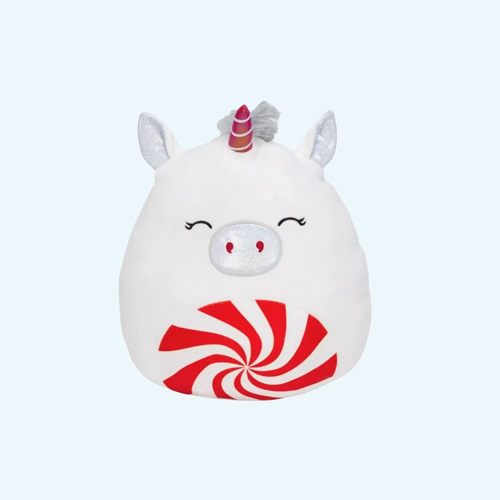 Soft Squishmallow plush shaped like a white unicorn with glittery ears, a multicolored horn, and a smiling face. On its belly, a red and white spiral candy design adds a festive and joyful touch.