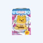 Pink and blue cardboard box with a Winnie the Pooh plush behind a clear plastic window. Set against a neutral background.