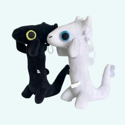 Black or white dragon plush toys on light blue background