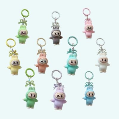 Labubu-style plush mini keychains in 10 different colors on light blue background