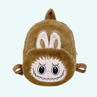 Labubu-style plush backpack in beige with ears sticking out above the front pocket. On light blue background