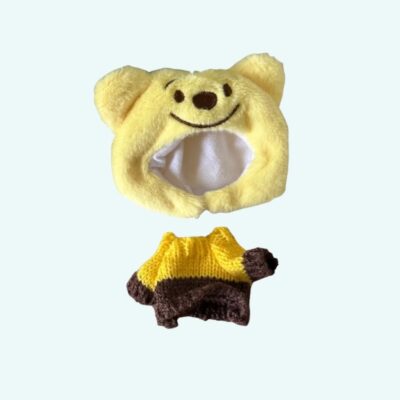Winnie the Pooh outfit for Labubu plush with yellow and brown sweater and yellow hood with Winnie’s smile. On light blue background