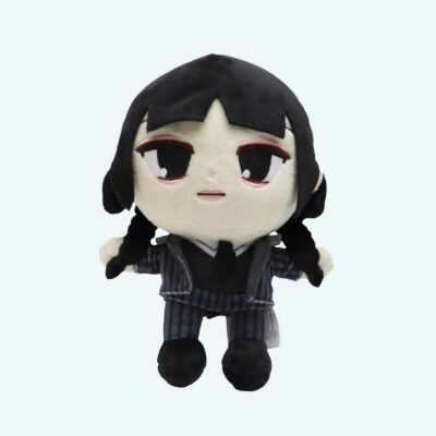 Plush toy representing Wednesday Addams, character from the Netflix series. She wears a black striped outfit, has black hair in two braids, and a serious expression. The plush is standing against a blue background.