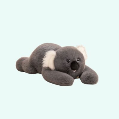 Weighted plush in the shape of a koala with dark gray fur and white ears on a light blue background.