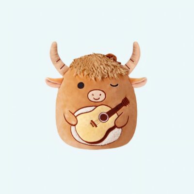 A Squishmallow bull plush with a guitar, front view on a light blue background