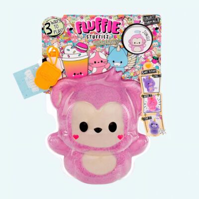 Fluffie Stuffiez plush shaped like a small pink monkey on a blue background