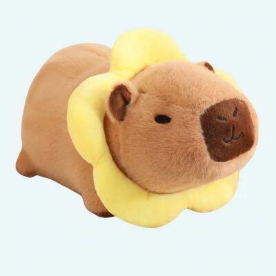 Kawaii capybara plush dressed as a yellow flower on a blue background