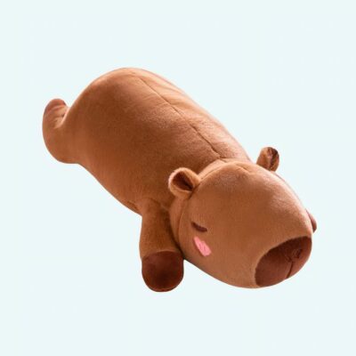 Fluffy capybara pillow plush lying down on a light blue background