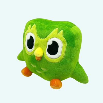 Green Duolingo Plush – Duo, three-quarter view on light blue background