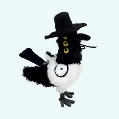 K-pop Demon Hunters plush Sussie the magpie wearing a black hat and three yellow eyes on a sky blue background.
