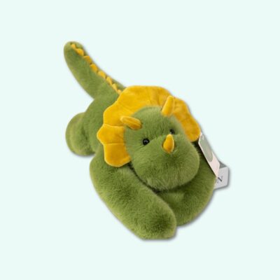 Weighted plush shaped like a green and yellow dinosaur, on a sky blue background.