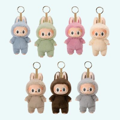 Labubu-inspired plush keychains in various colors on a sky blue background