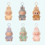 Labubu style plushies in sitting position on sky blue background